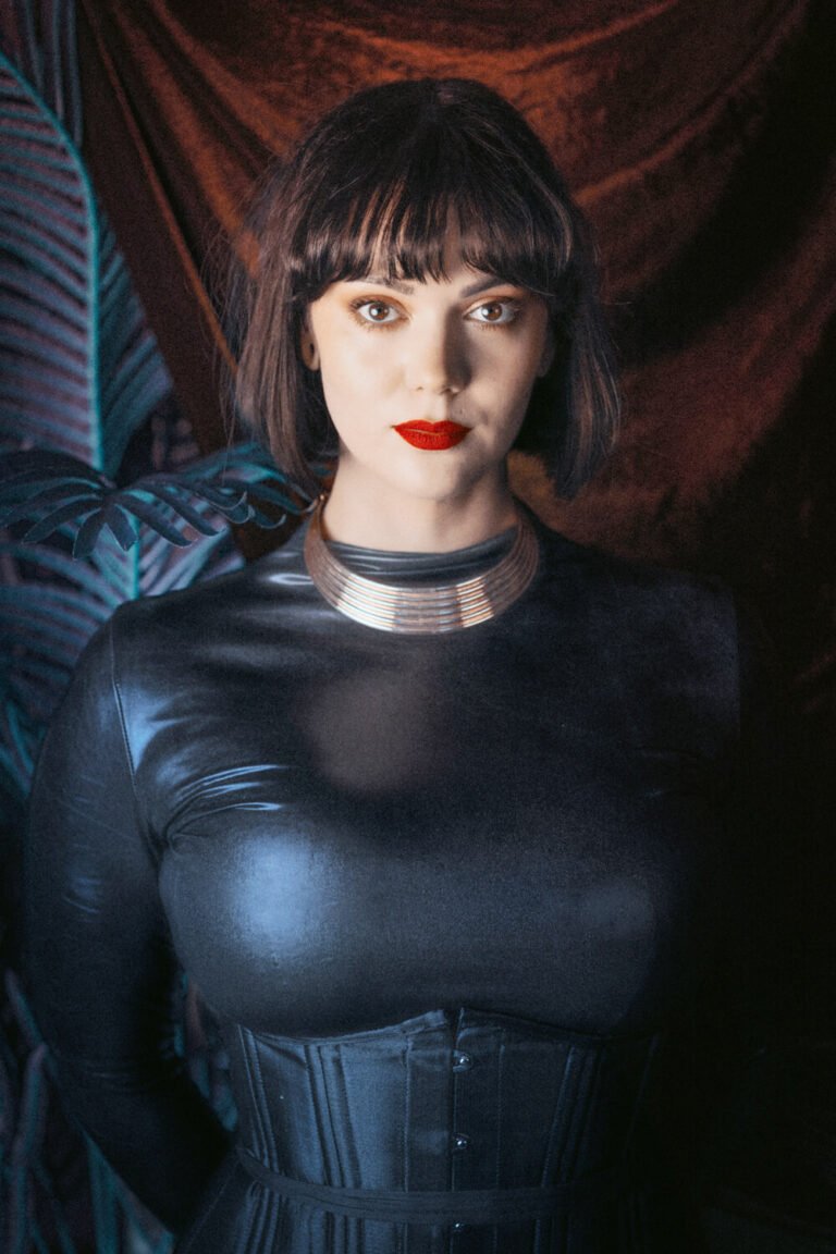 Cincinnati dominatrix Countess Cecilia gives a commanding look to the camera, wearing a latex bodysuit and black corset.